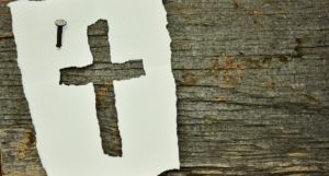 Cross made out of paper on Wood